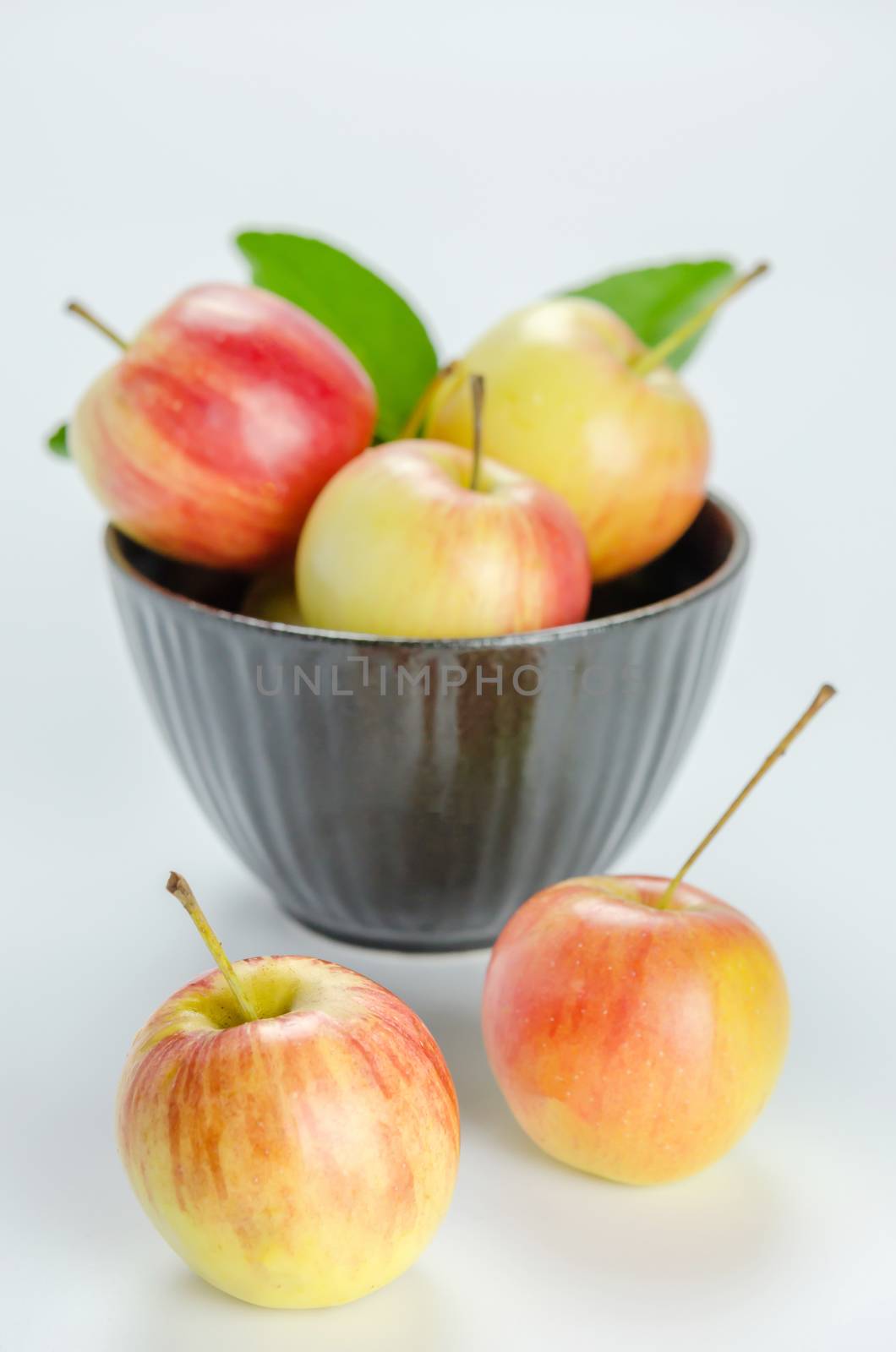 Red and yellow apple with black bowl , organic fresh fruit