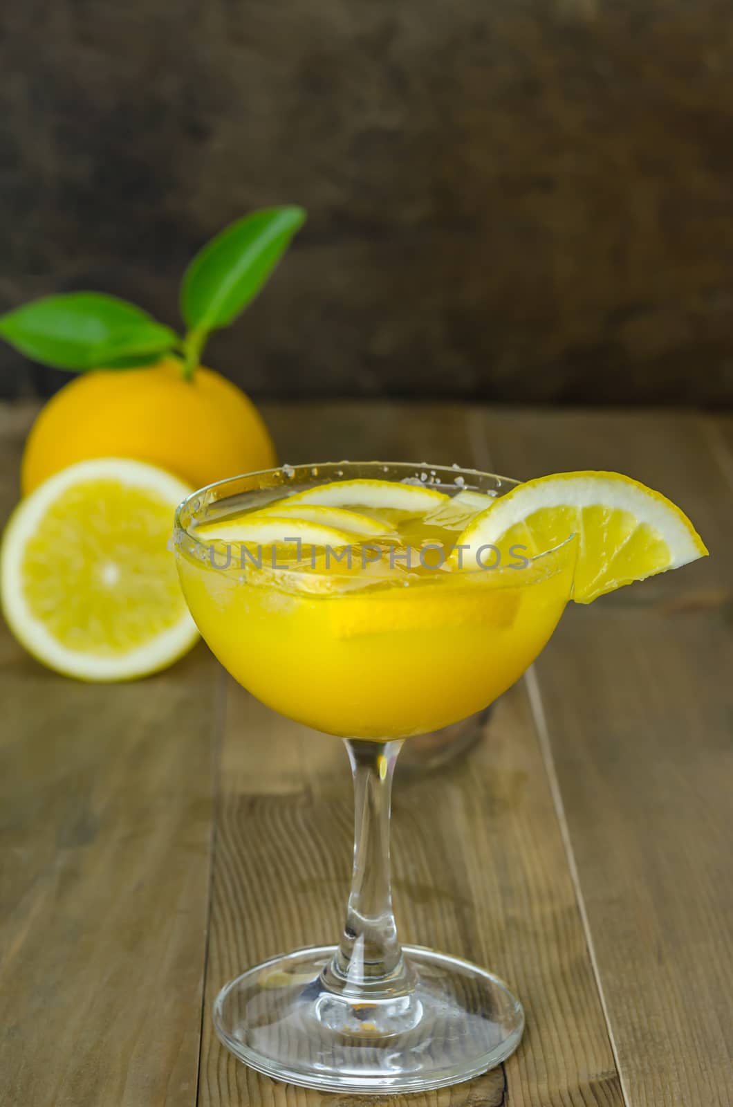 Fresh orange juice on wooden table over grunge background