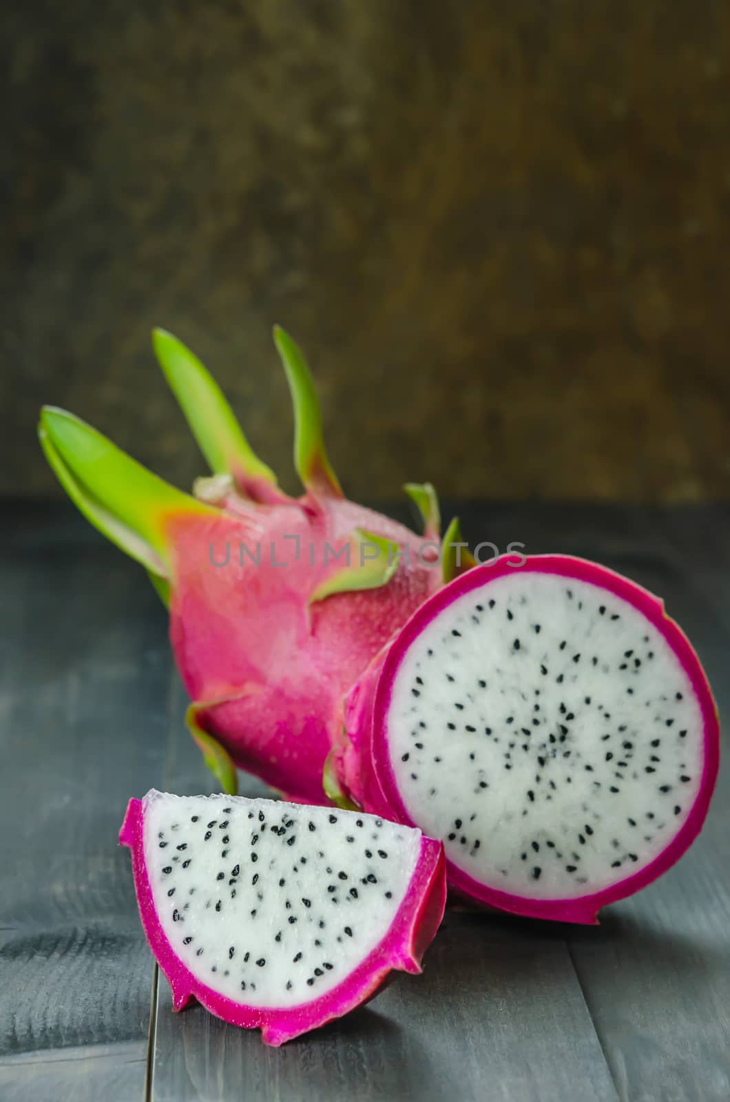 Ripe Dragon fruit or Pitaya with slice on wooden background , still life