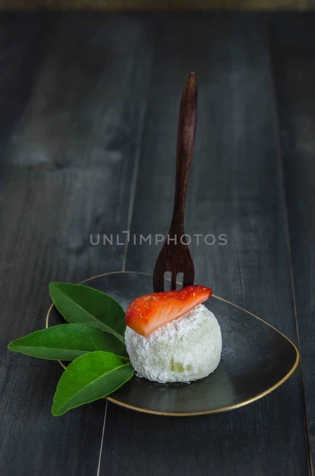 Strawberry Daifuku Mochi Japanese dessert on dish over wooden background , still life