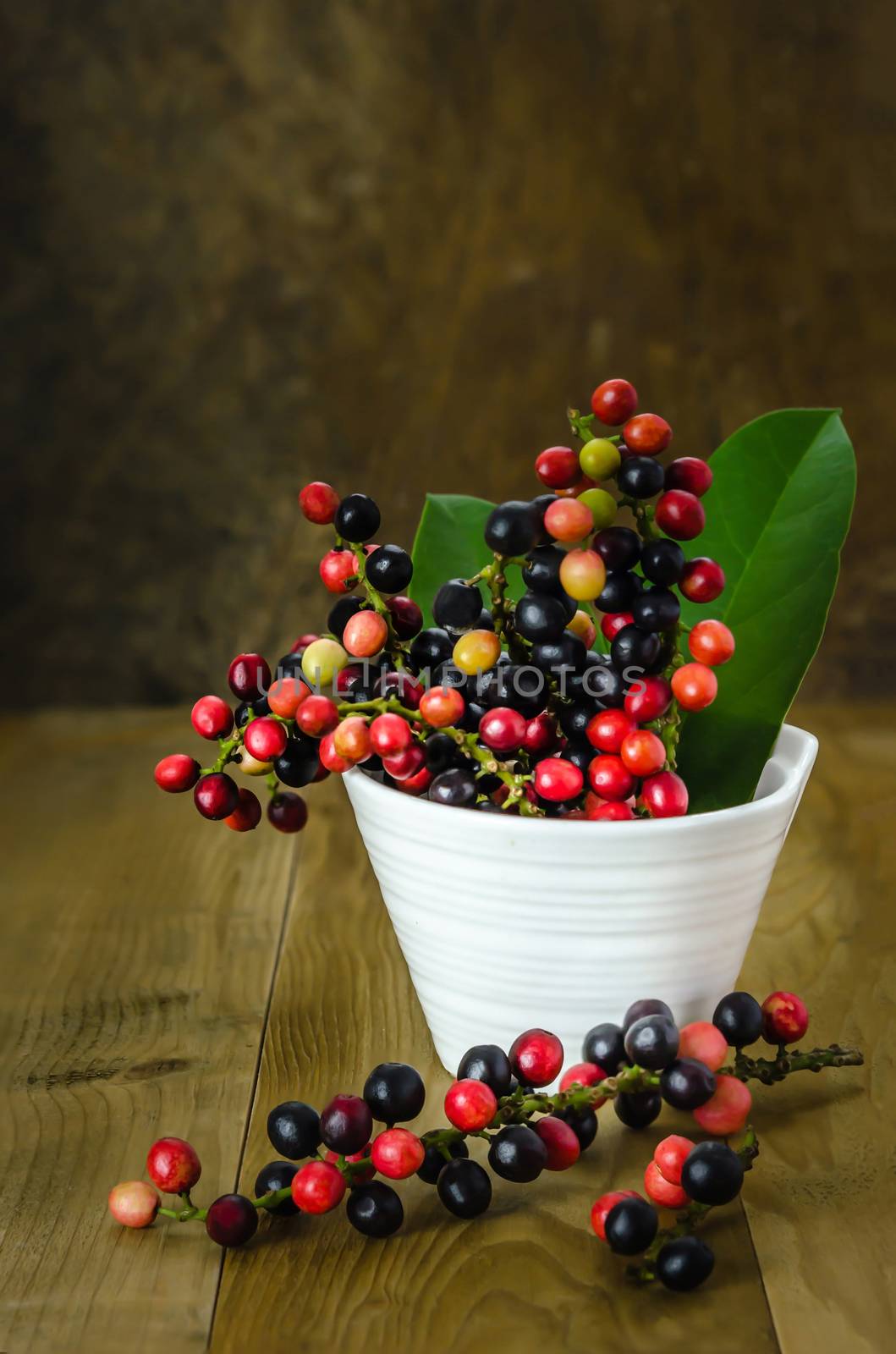 Thai Blueberry in white bowl over wooden background , still life