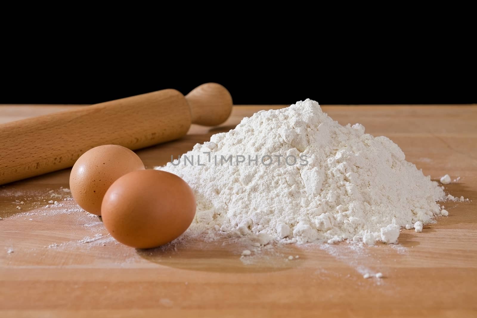 Flour and eggs with rolling-pin