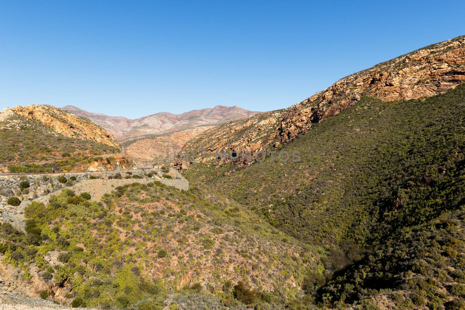 Roads and Mountains Landscape - South Africa's geography. South Africa occupies the southern tip of Africa, its long coastline stretching more than 2 500km from the desert border with Namibia on the Atlantic coast, southwards around the tip of Africa, then north to the border with subtropical Mozambique on the Indian Ocean.