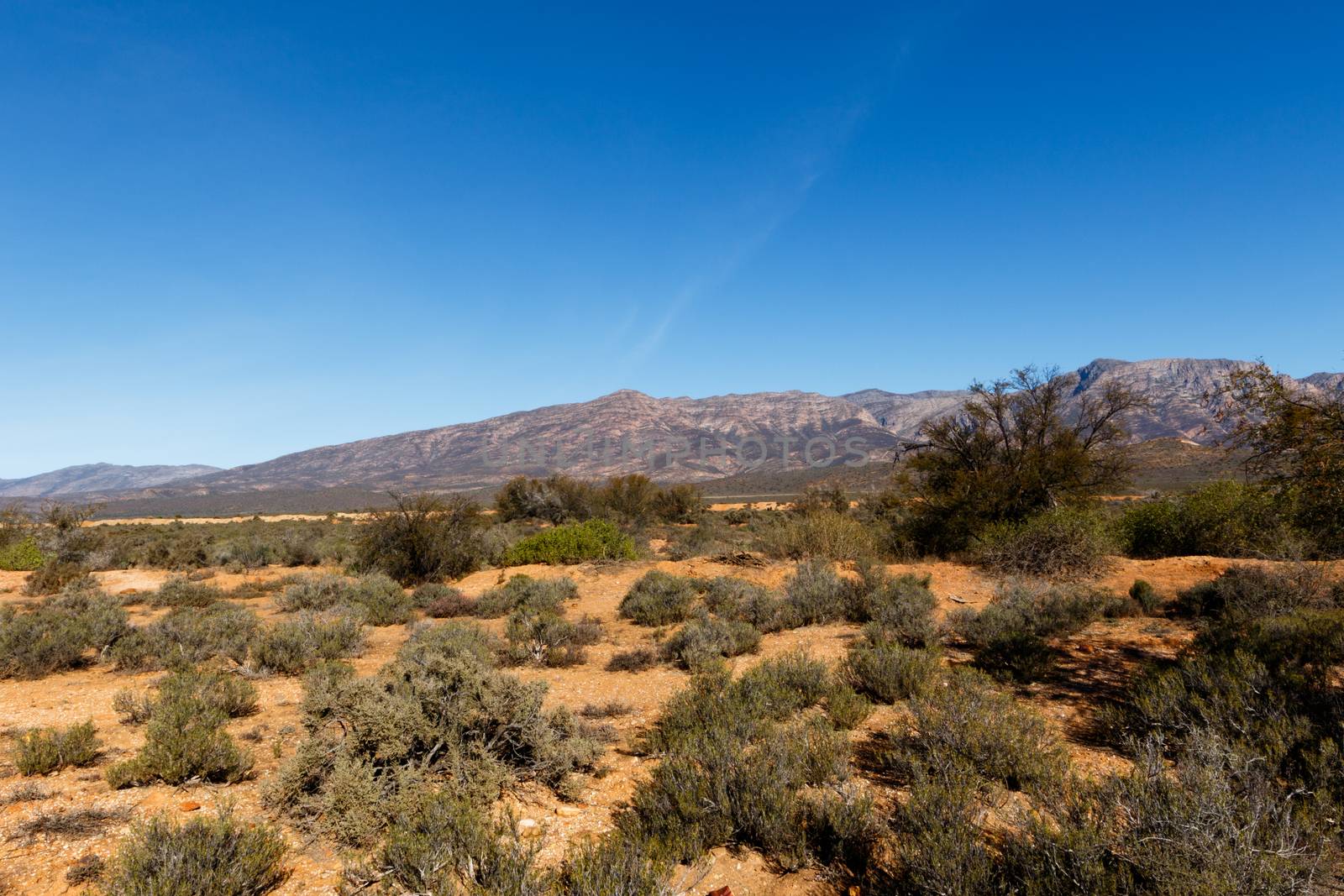 Dry Landscape - South Africa's geography. South Africa occupies the southern tip of Africa, its long coastline stretching more than 2 500km from the desert border with Namibia on the Atlantic coast, southwards around the tip of Africa, then north to the border with subtropical Mozambique on the Indian Ocean.