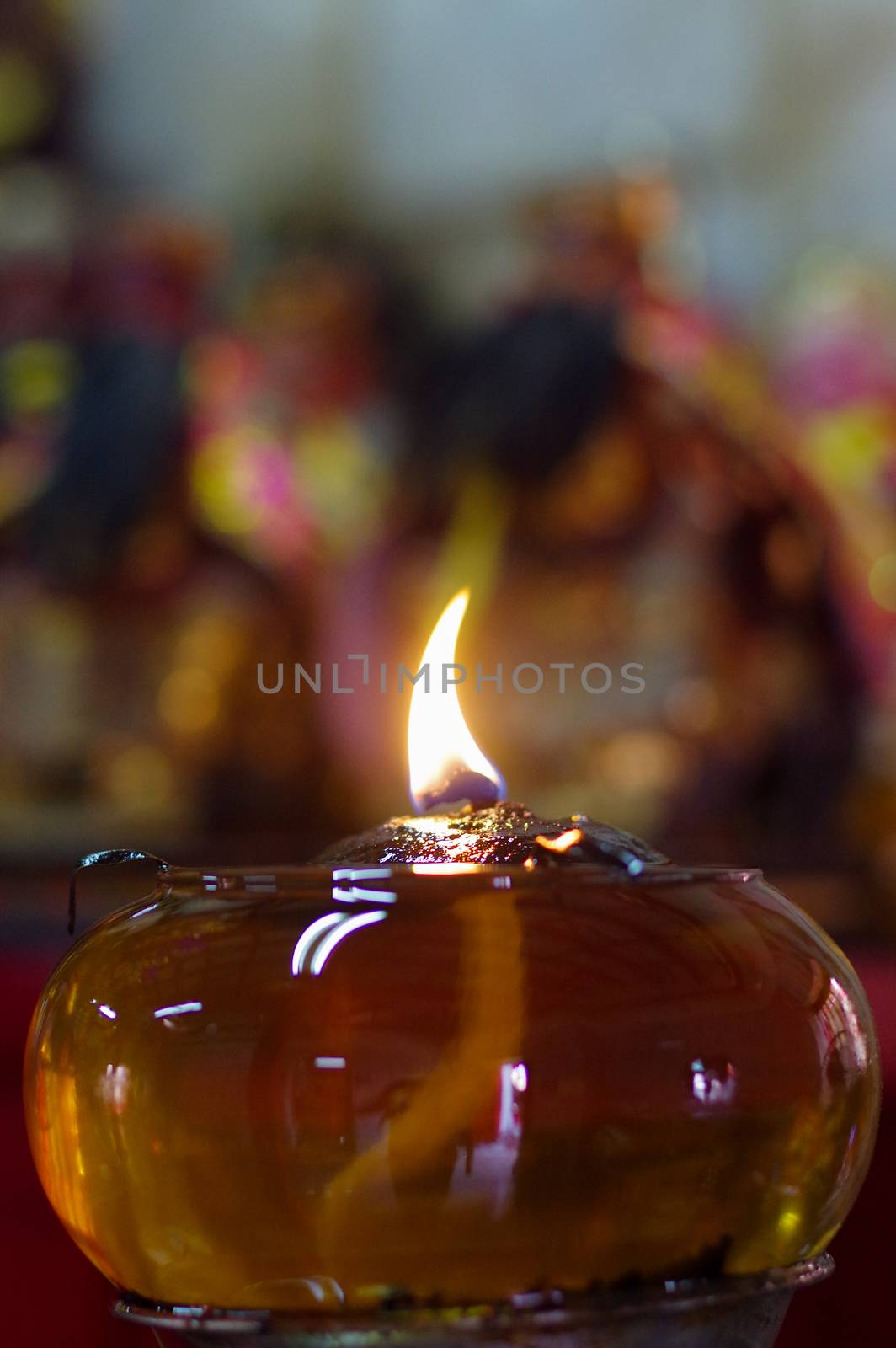 Burning oil lamps at religious temple in Thailand