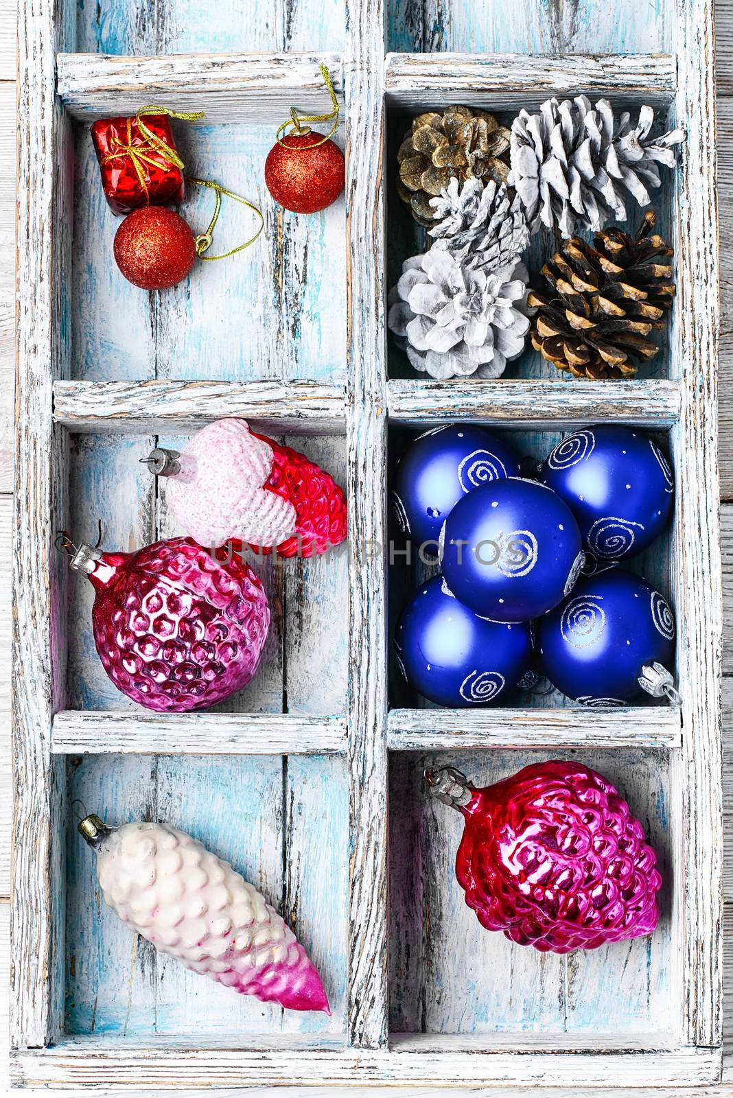 Wooden box with Christmas decorations and the tree
