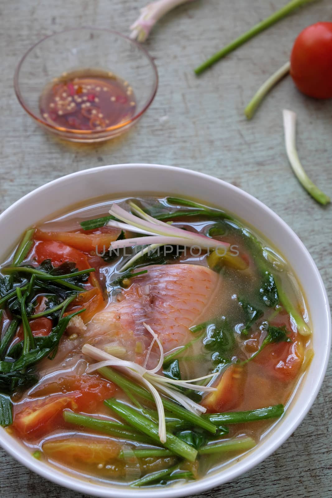 Vietnamese food, fish soup from tomato, onion, celery and red tiapia. Is popular daily dish that nutrition and good for health