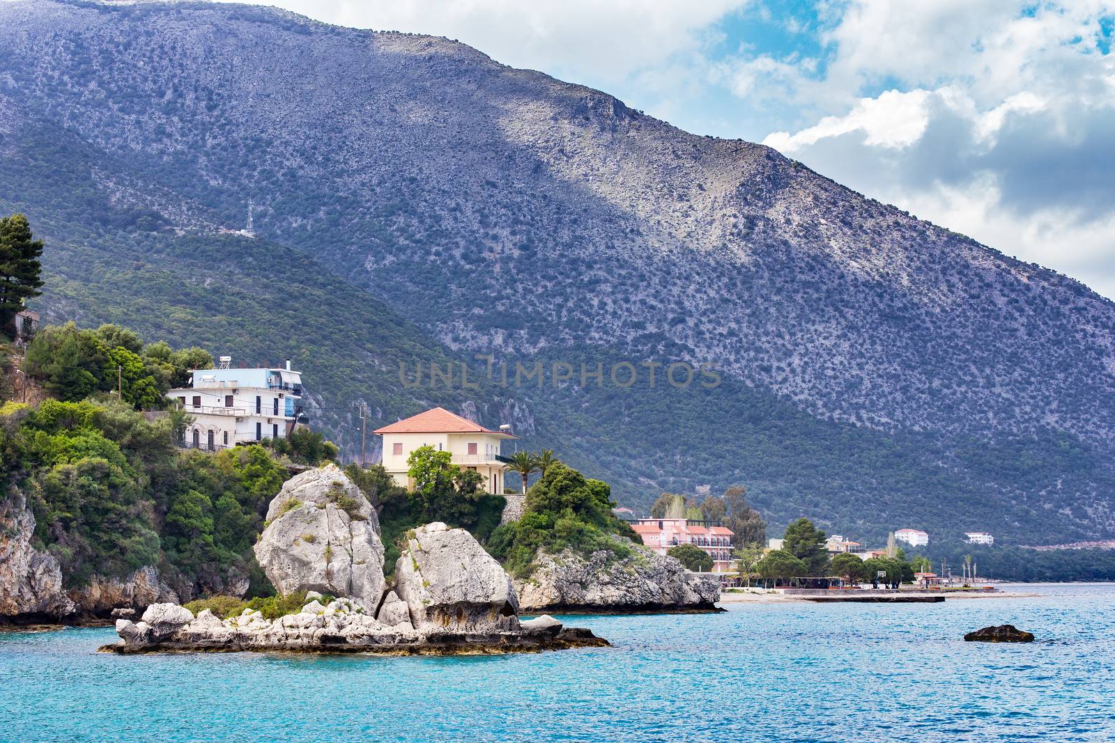 Houses rocks and mountain at greek ocean