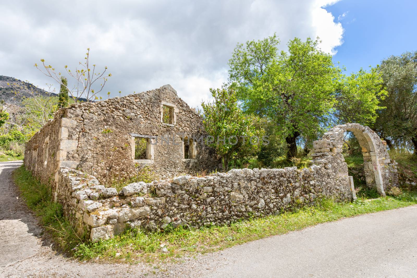 Old historic house as ruins along road by BenSchonewille