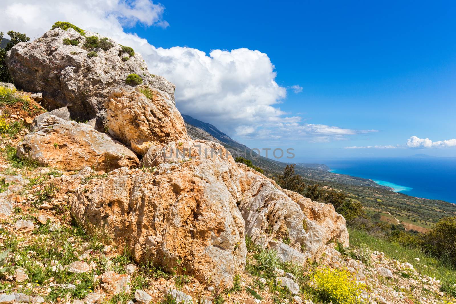 Orange rocks on mountain at greek coast by BenSchonewille