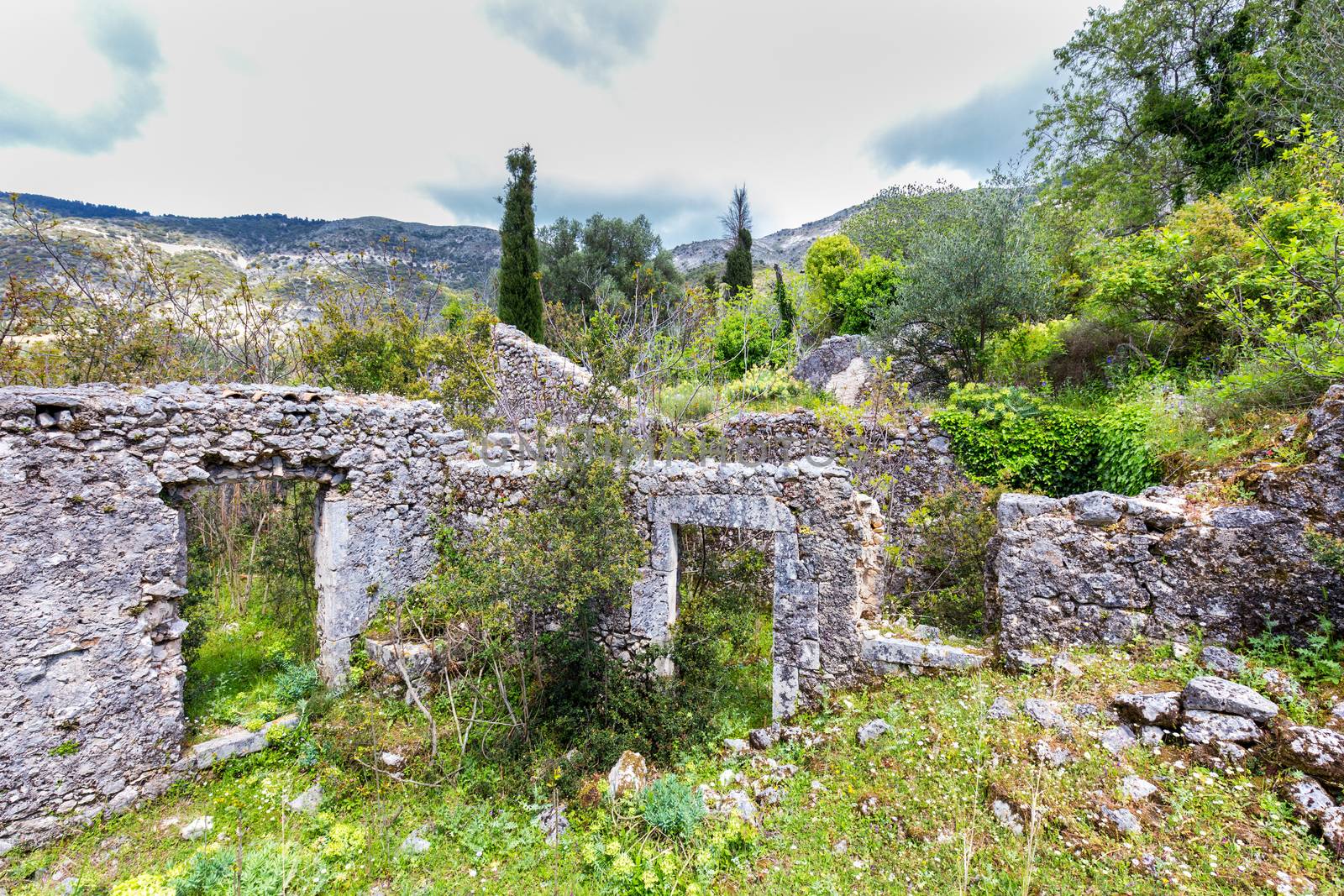 Old historic walls as ruins in landscape of Greece by BenSchonewille