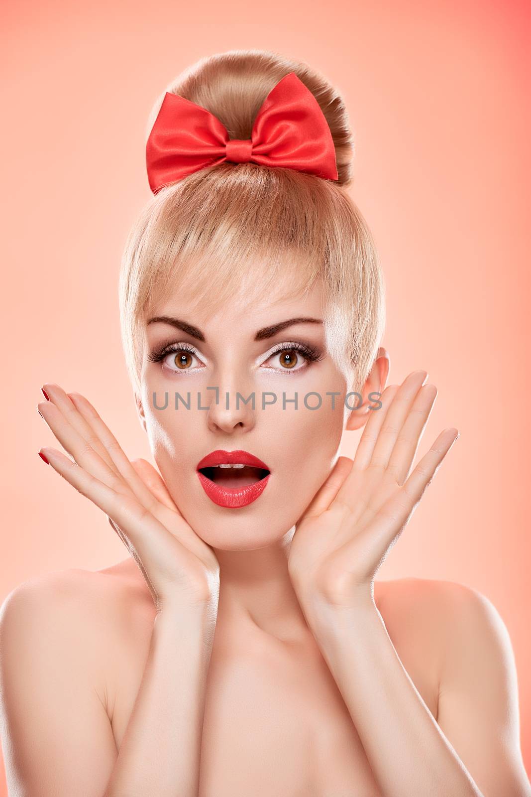 Beauty fashion portrait happy woman surprised looks. Sensual attractive pretty nude blonde sexy girl, Pinup hairstyle, red bow. Unusual emotional playful. Romantic, retro vintage, skincare on pink