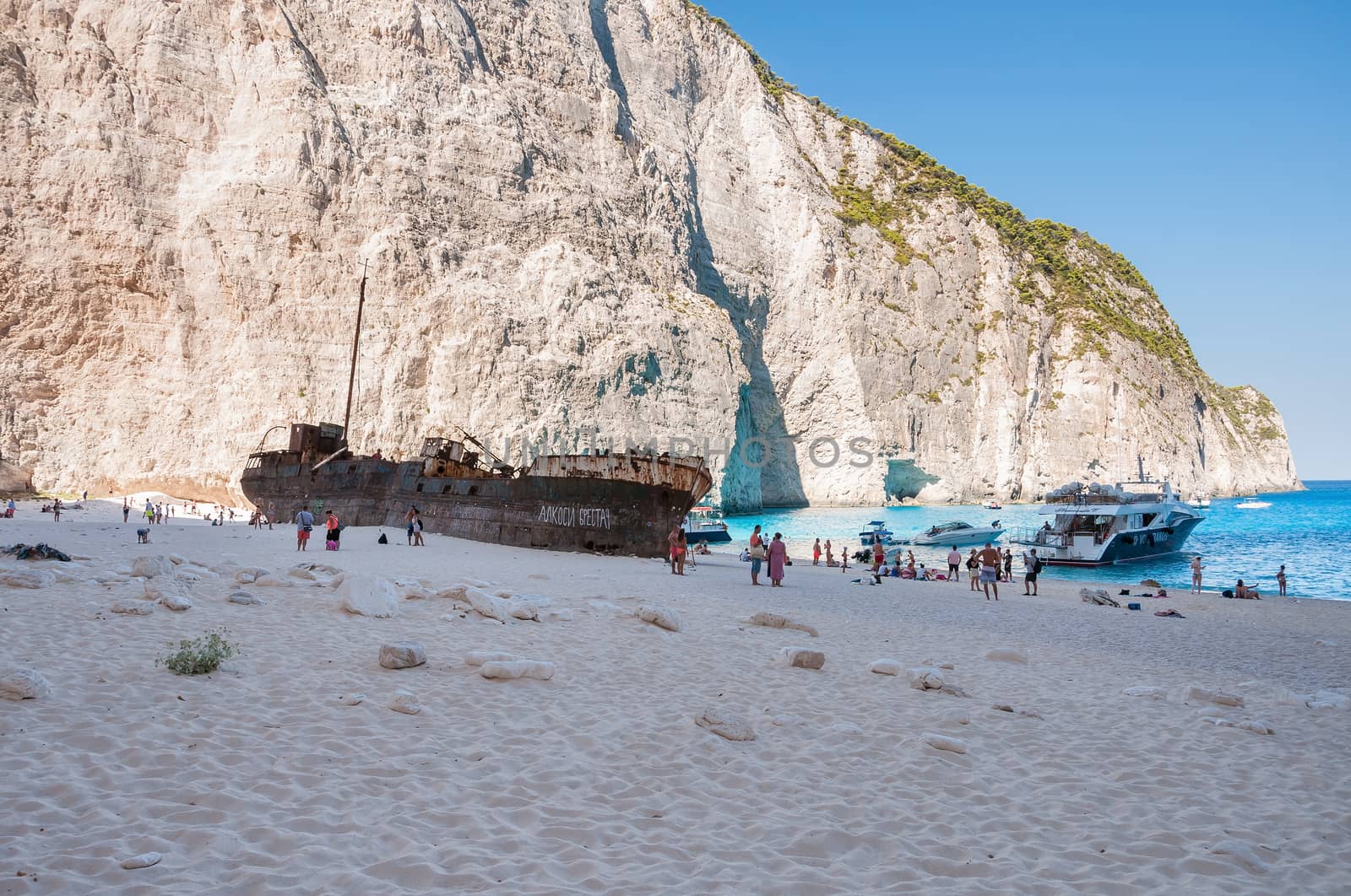 Tourists at the Navagio Beach on Zakynthos Island by mkos83