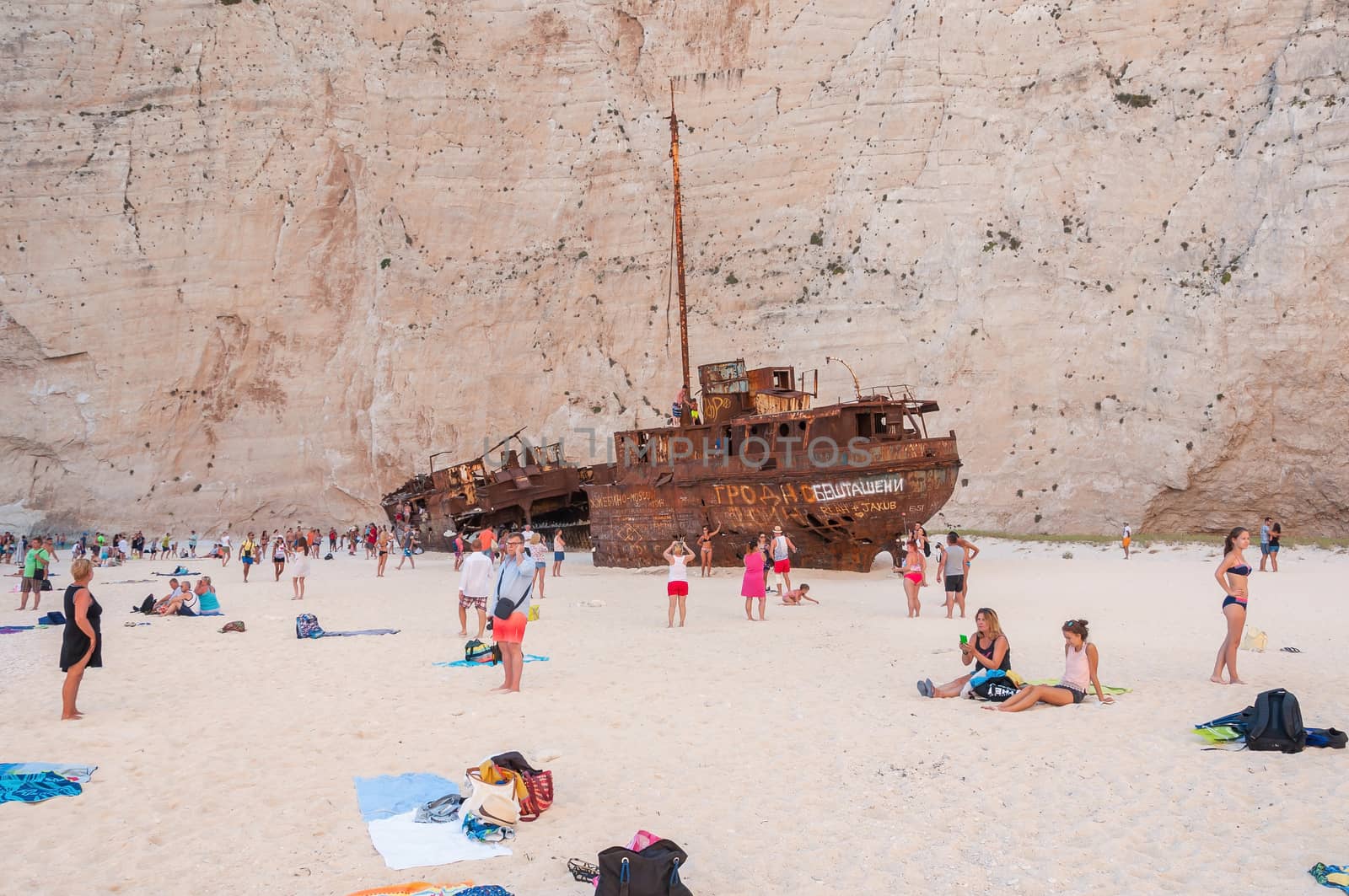 Zakynthos, Greece - August 27, 2015: Tourists at the Navagio Beach and view of Shipwreck on Zakynthos Island. Famous Navagio Beach is the most popular tourist attraction on the island.