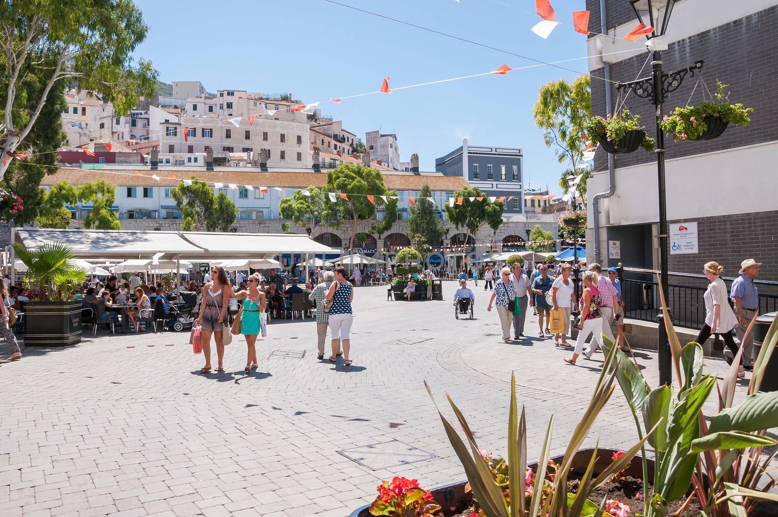 Gibraltar, United Kingdom - August 27, 2014: Tourists visit Grand Casemates Square. The square is lined with numerous pubs, bars and restaurants and acts as the gateway into Gibraltar's city centre.