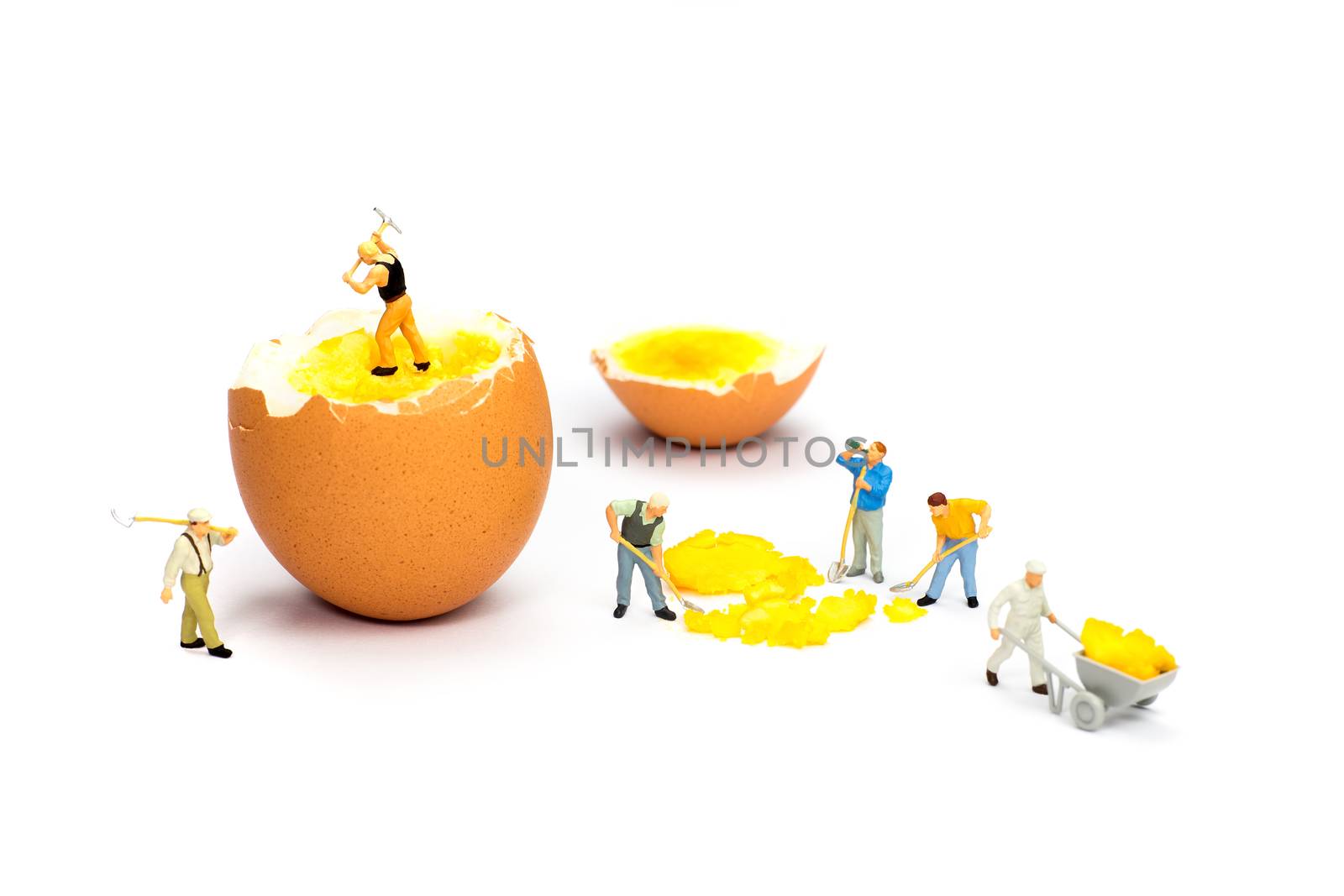 Team of miniature human figurines transporting chicken egg yolk by BenSchonewille