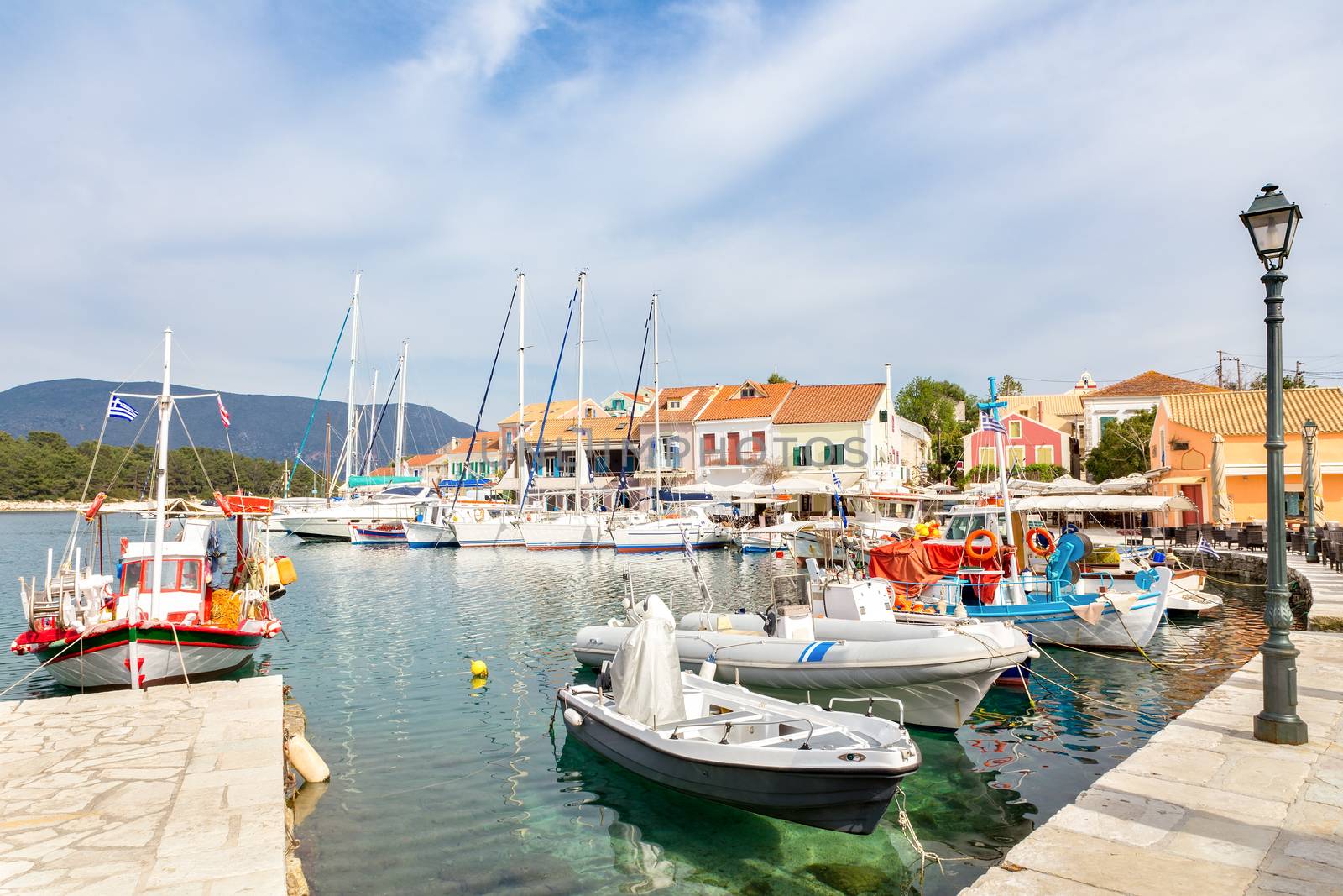 Greek harbor with sailing boats in Fiskardo by BenSchonewille