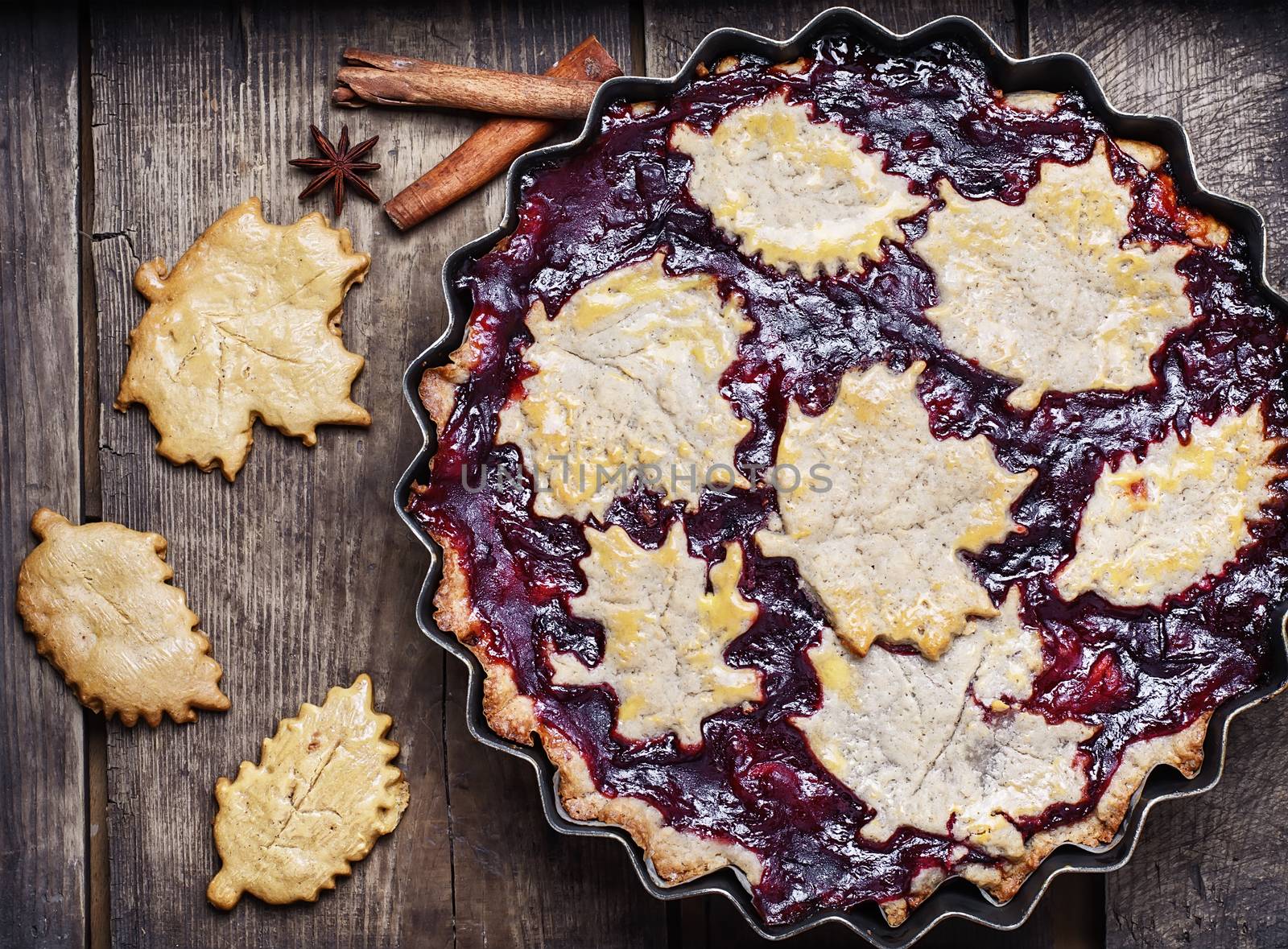 Autumn pie with plum decorated cakes in the form of leaflets