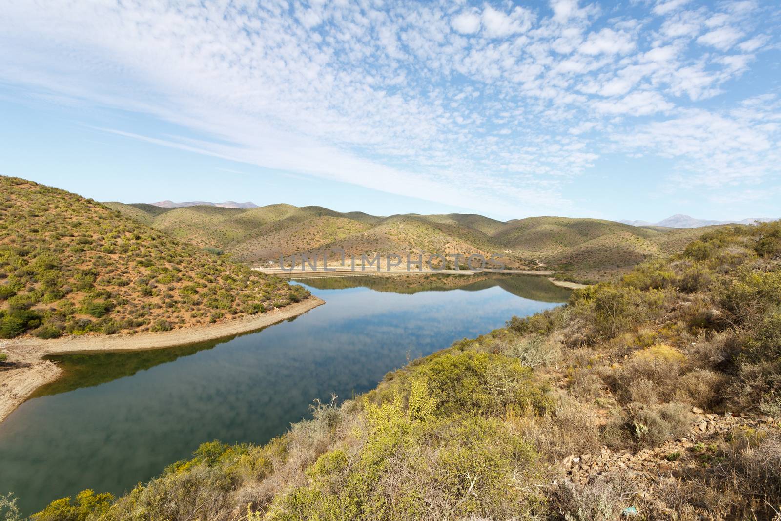 Clouds and green mountains at The Calitzdorp Dam