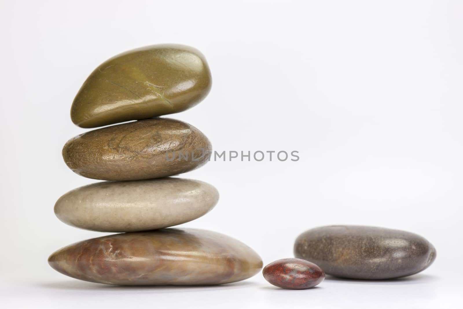 Pile of colourful boulders of natural stone on a white background
