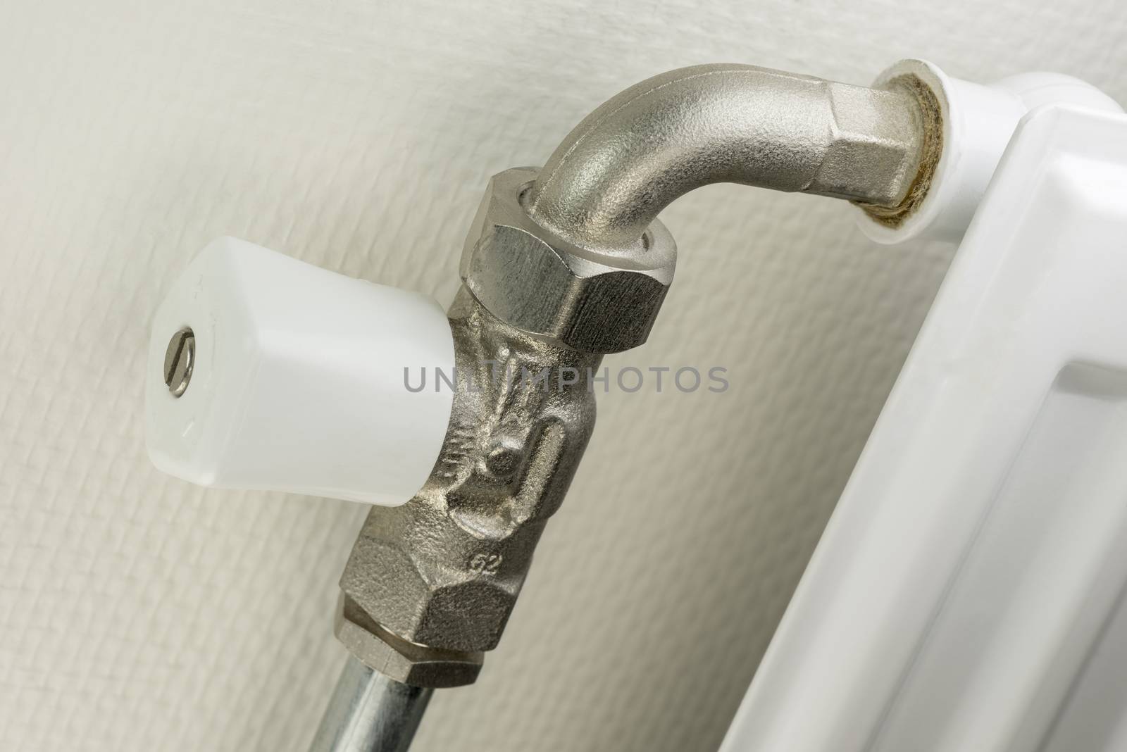 White radiator button on heater tube with a white heating element
