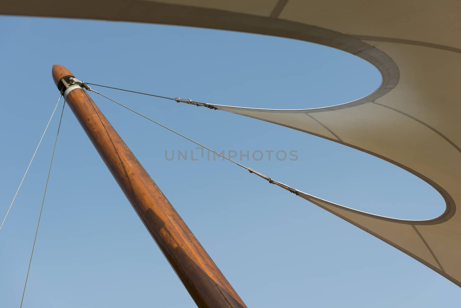 Organic shaped tent canvas roof to a wooden post
