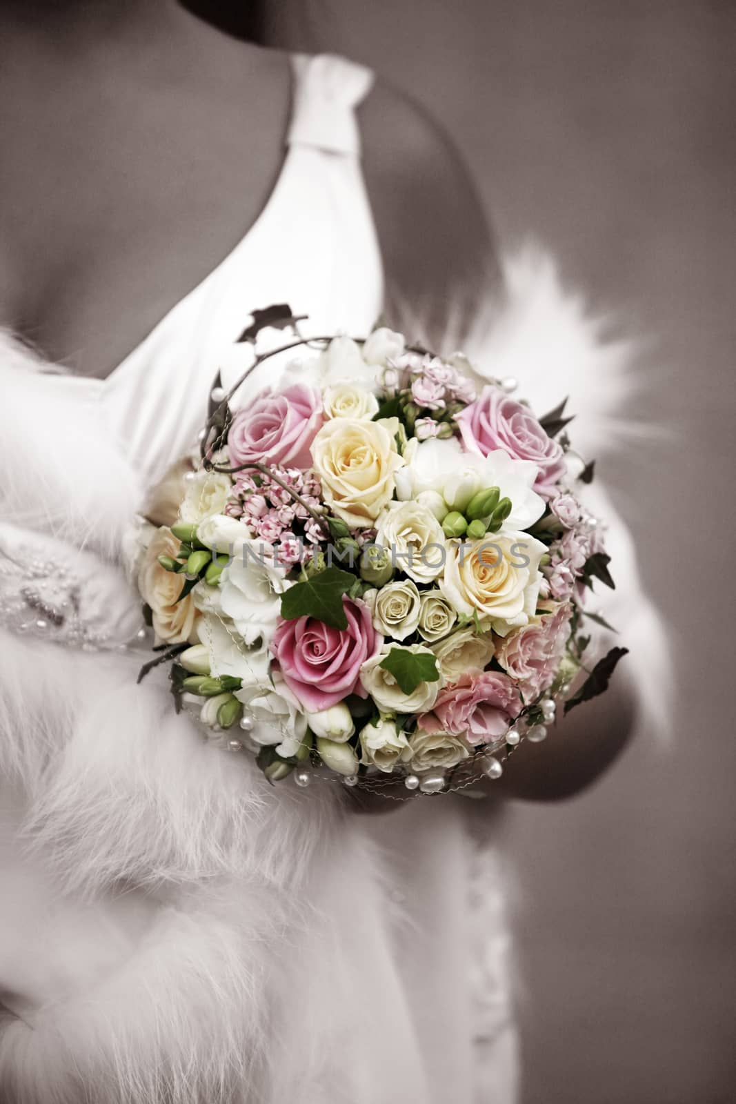 The bride holds a wedding bouquet