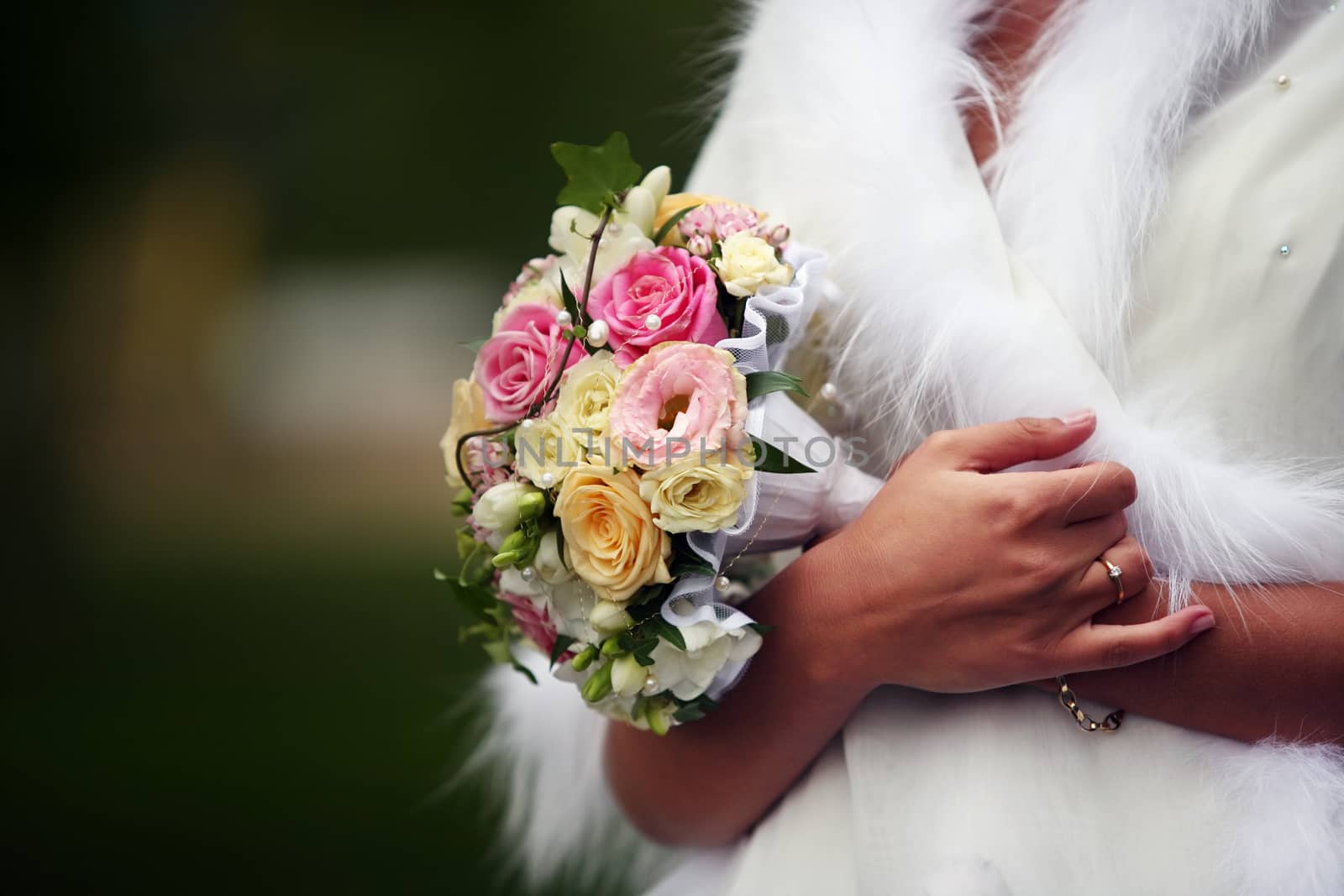 The bride holds a wedding bouquet