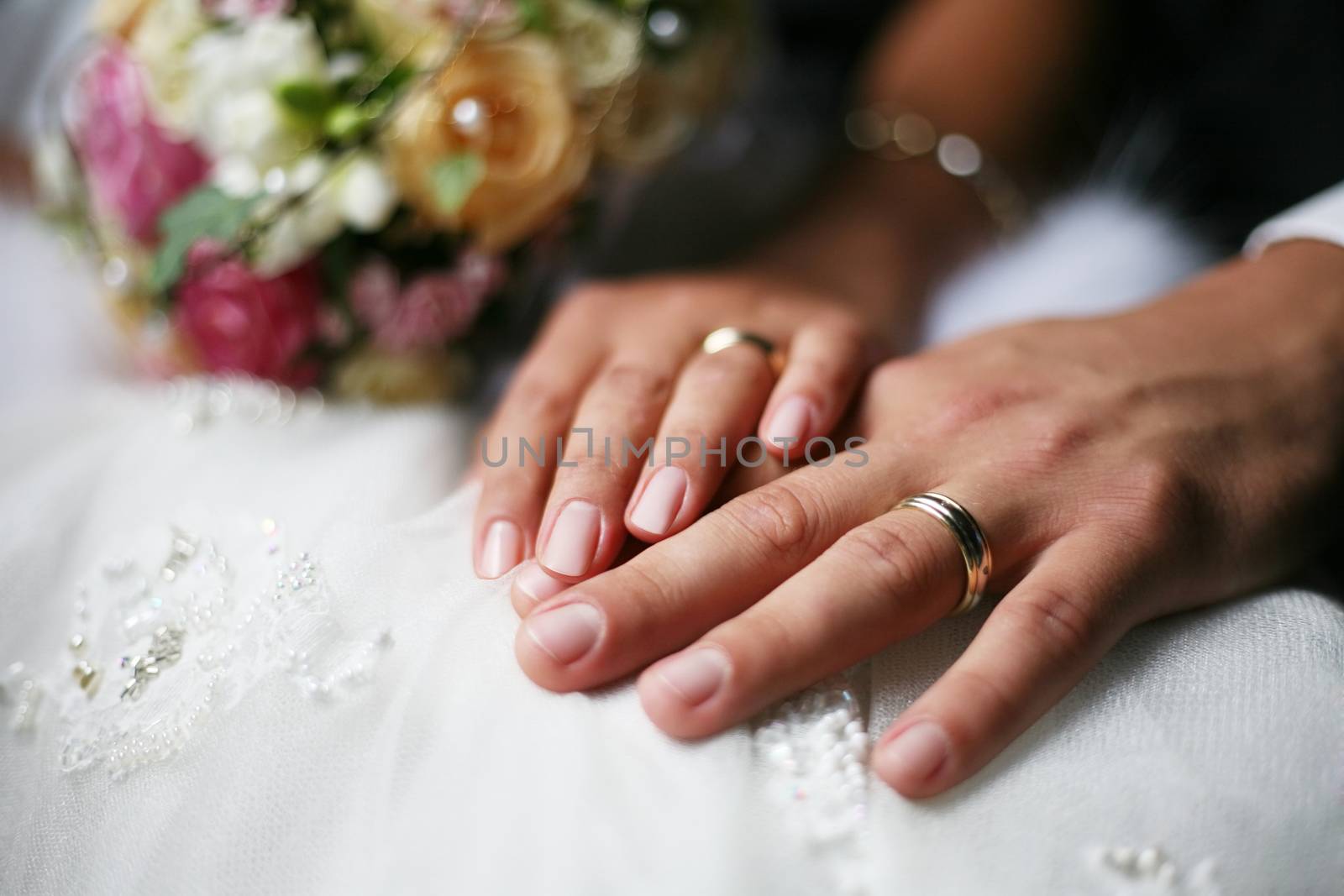 Hand of the groom and the bride with wedding rings