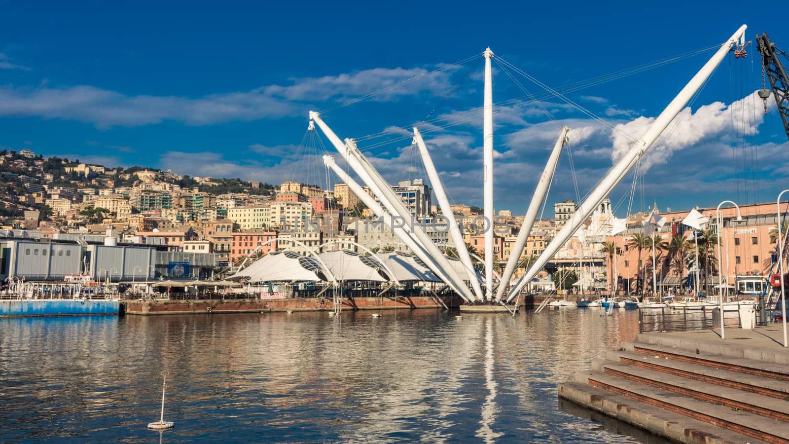 The Bigo is a 1992 building by Renzo Piano comissioned by the city and inspired from an ancient derrick for the ships servicing the old port of Genoa, Italy. Its longest arm (above the vantage point) lifts a cabin with tourist for a nice view over the city, while some others are supporting the roof of the Piazza del Feste (right).