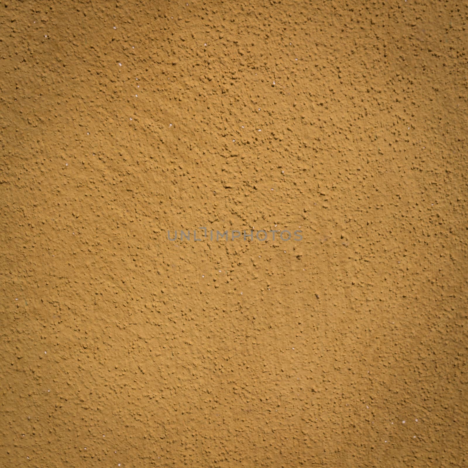 Mustard wall background and texture with vignetting and blank copyspace for text or advertising.