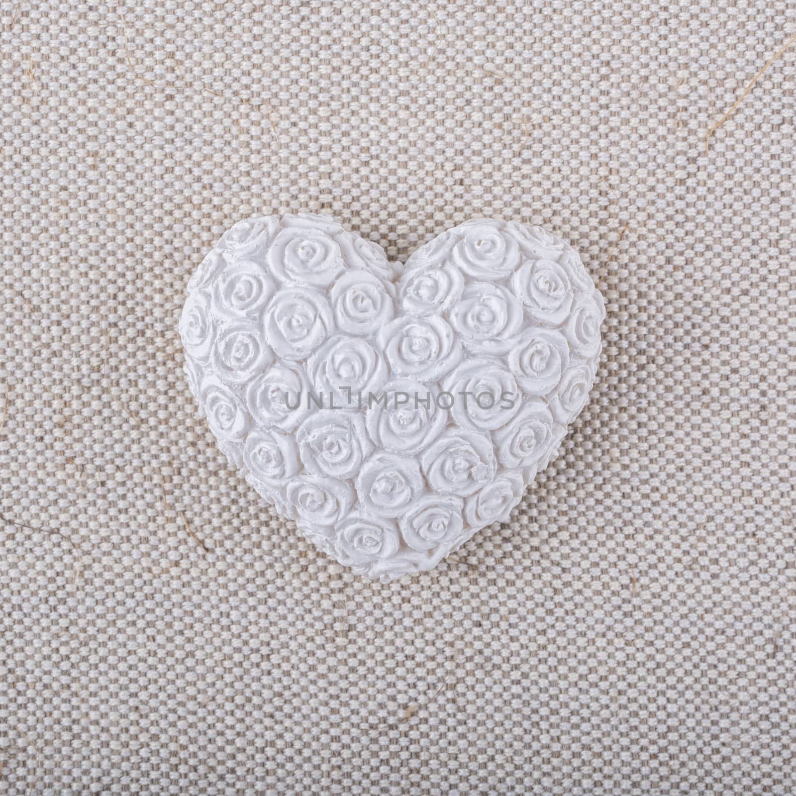 White heart on a beige fabric