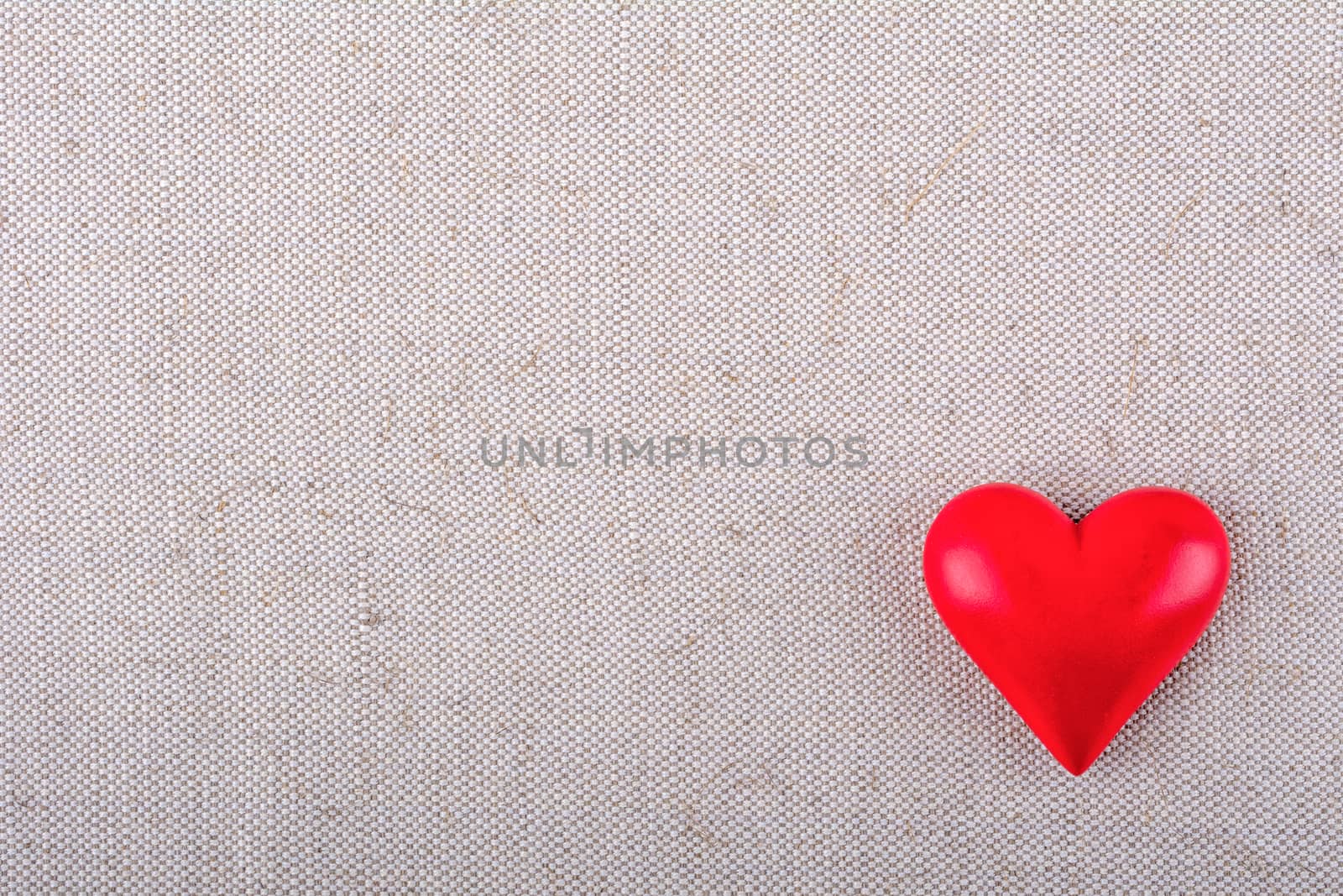 Red heart on a beige fabric