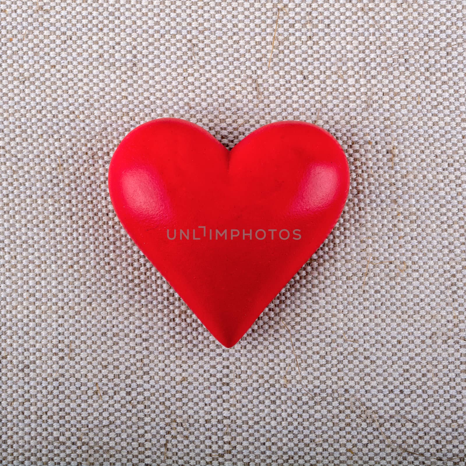 Red heart on a beige fabric