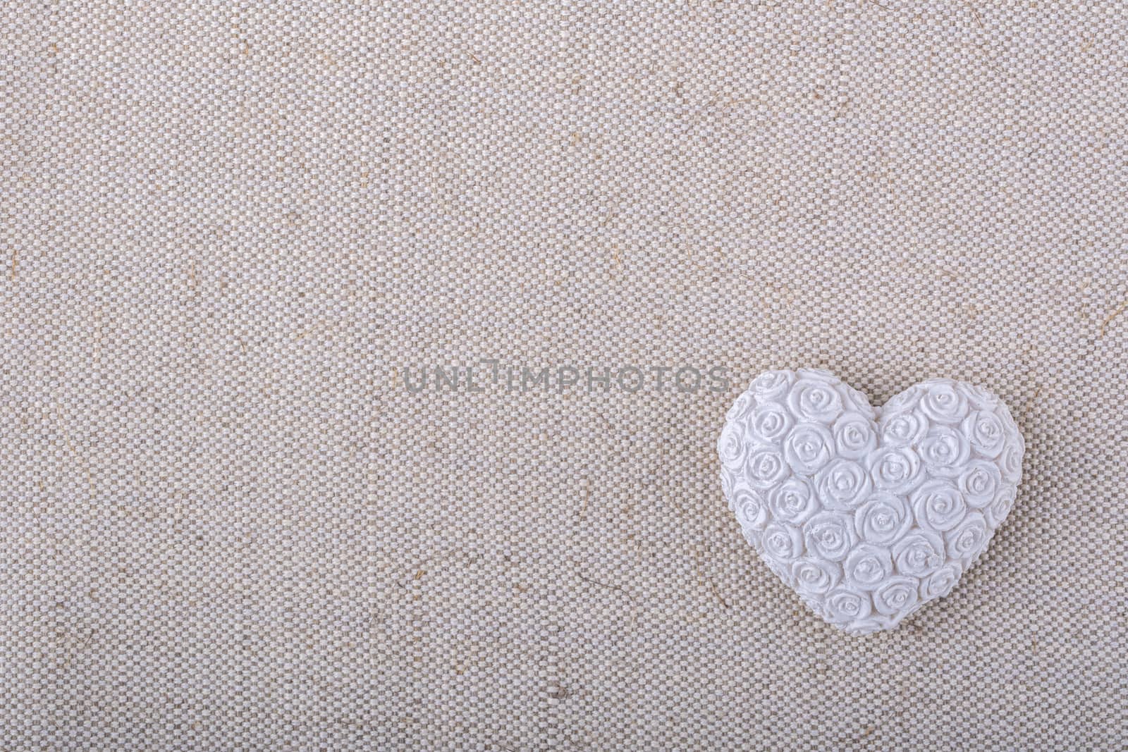 White heart on a beige fabric