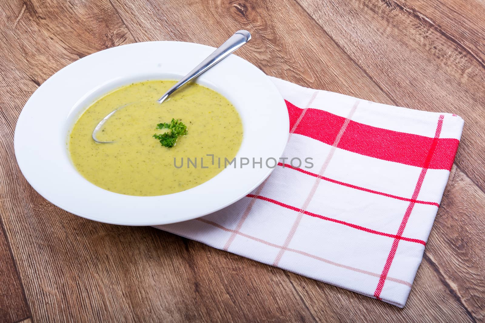 Cream of broccoli soup on a white plate