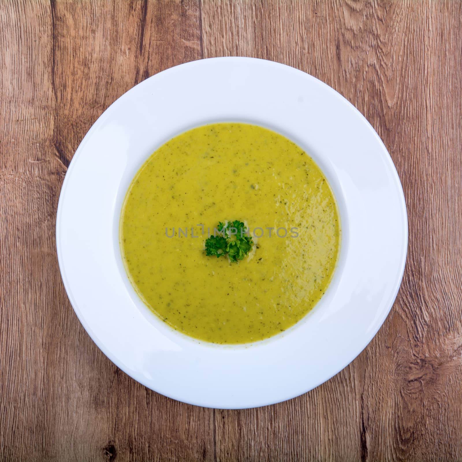 Cream of broccoli soup on a white plate