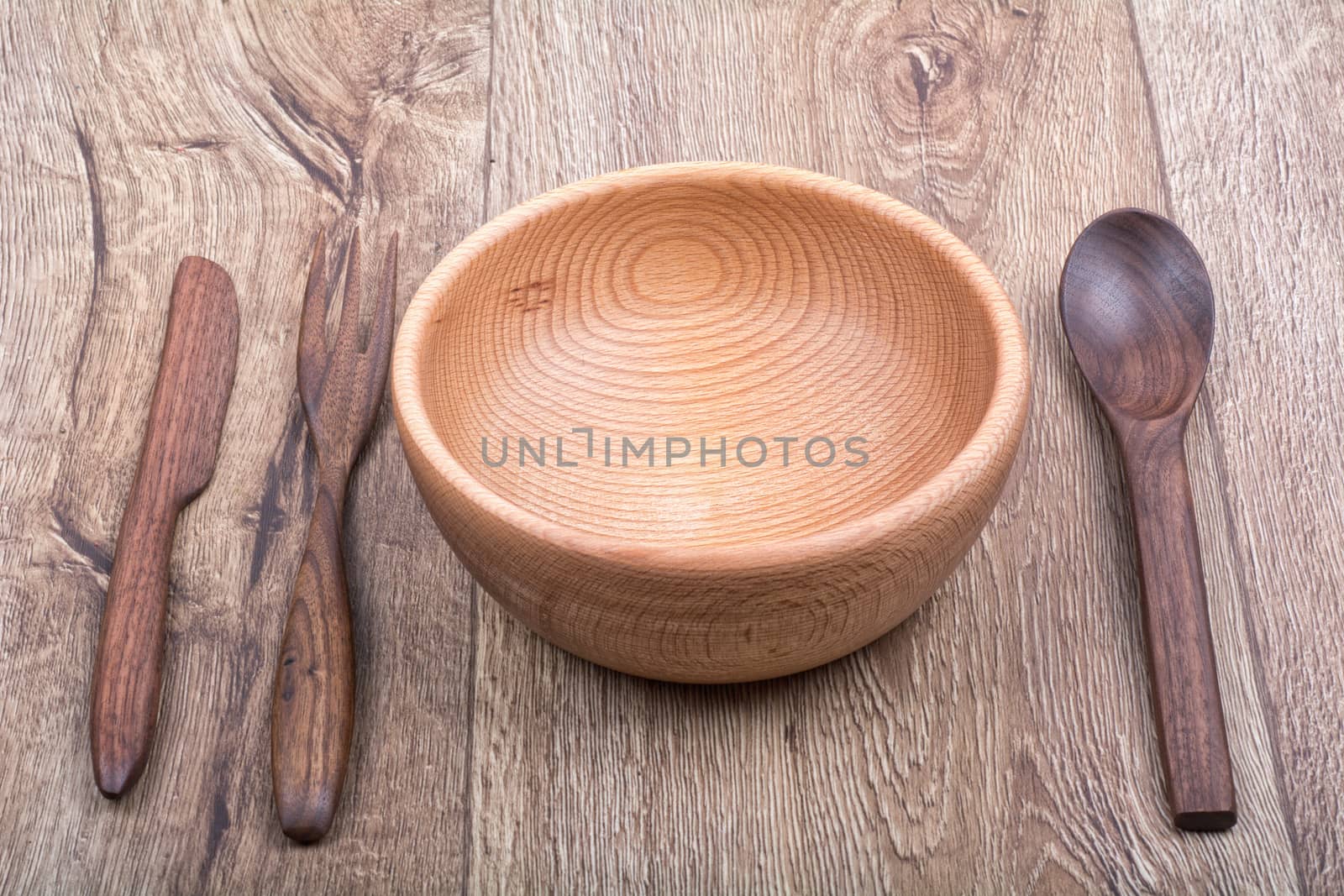 Wooden cutlery on a brown wooden background background