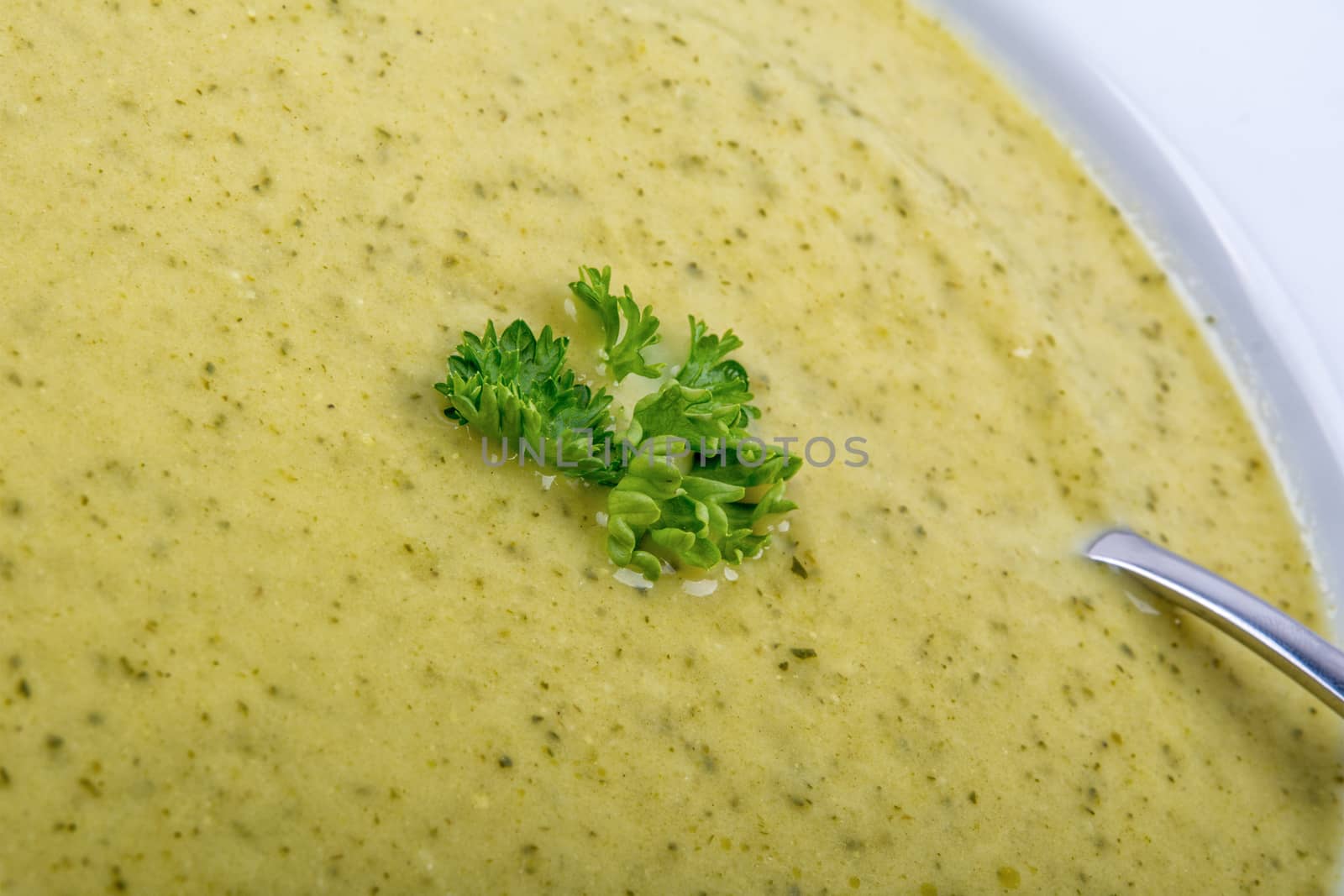Cream of broccoli soup on a white plate