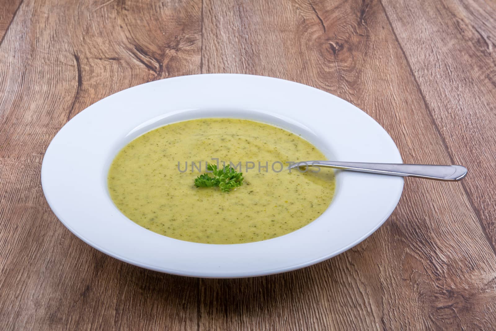 Cream of broccoli soup on a white plate