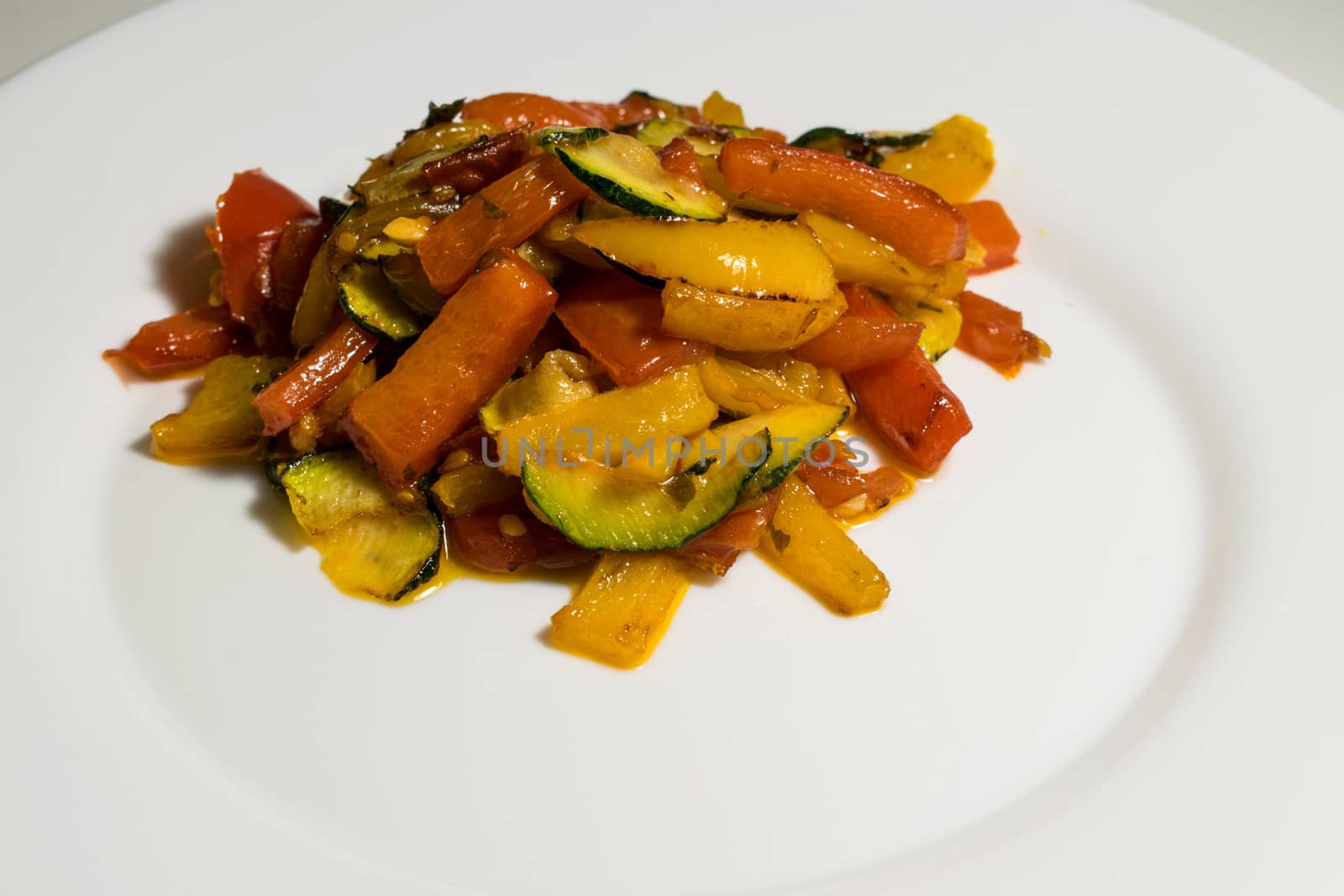 Fried colored vegetables in a white background