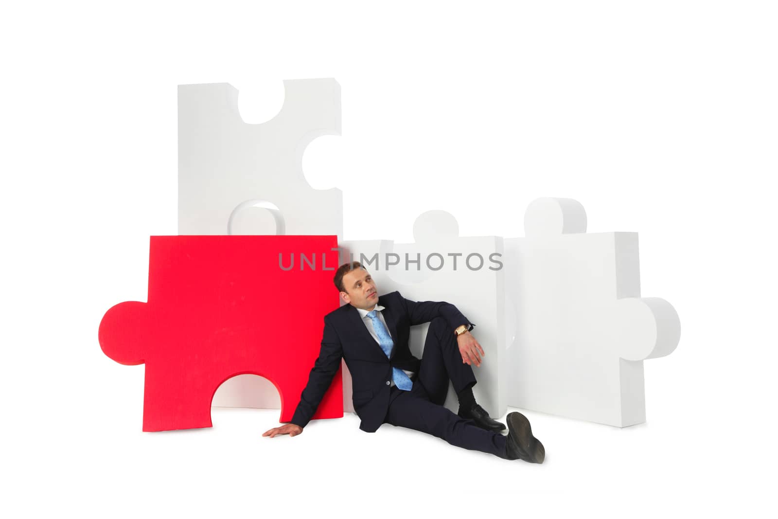 Business man thinking about problem solution near big puzzle