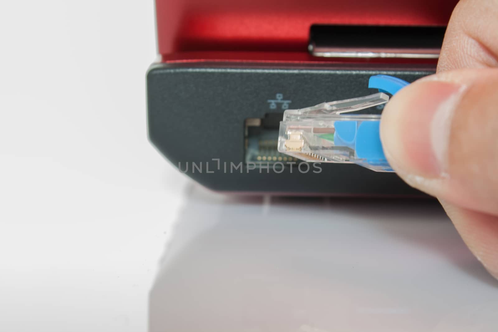 Connecting lan port to laptop computer isolated on white background