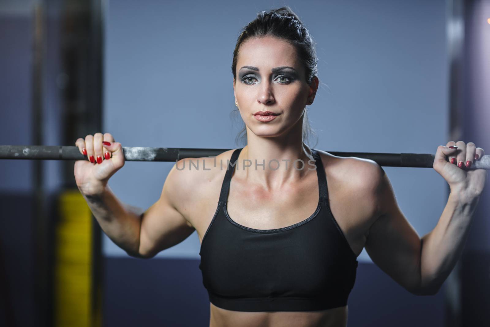 Powerful attractive muscular woman CrossFit trainer do workout with barbell by mrakor