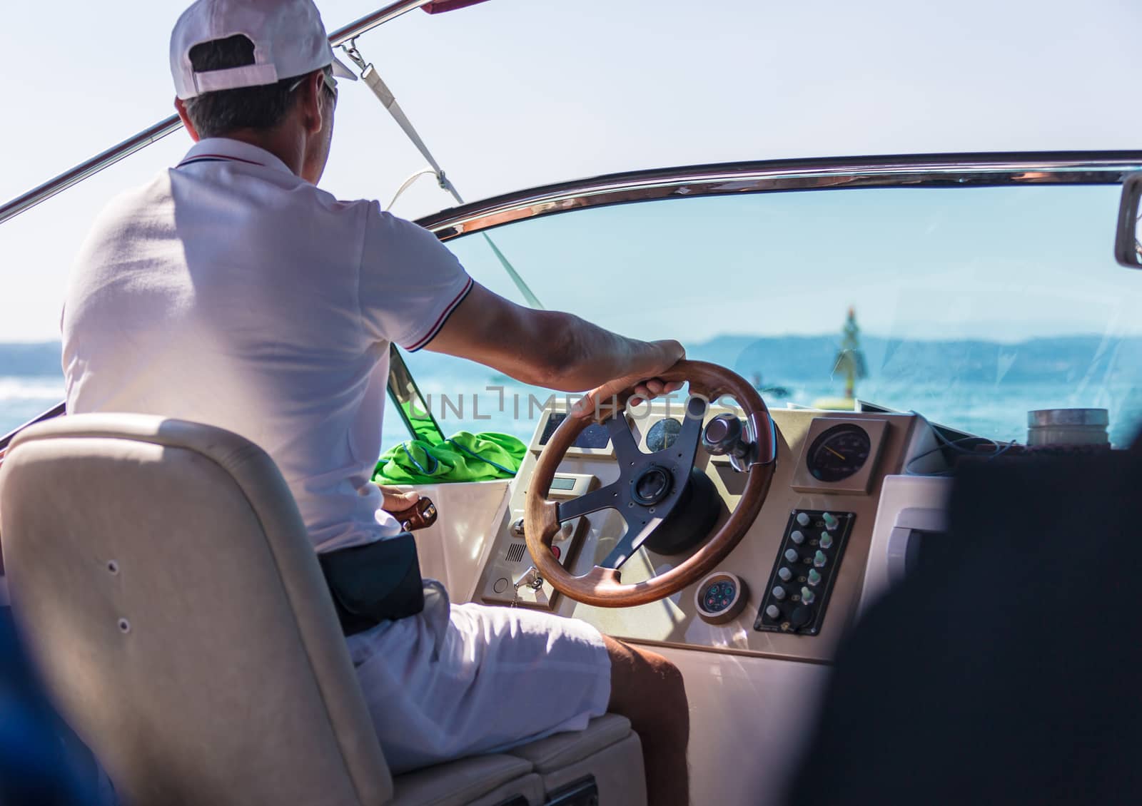 man behind the wheel of a motor boat