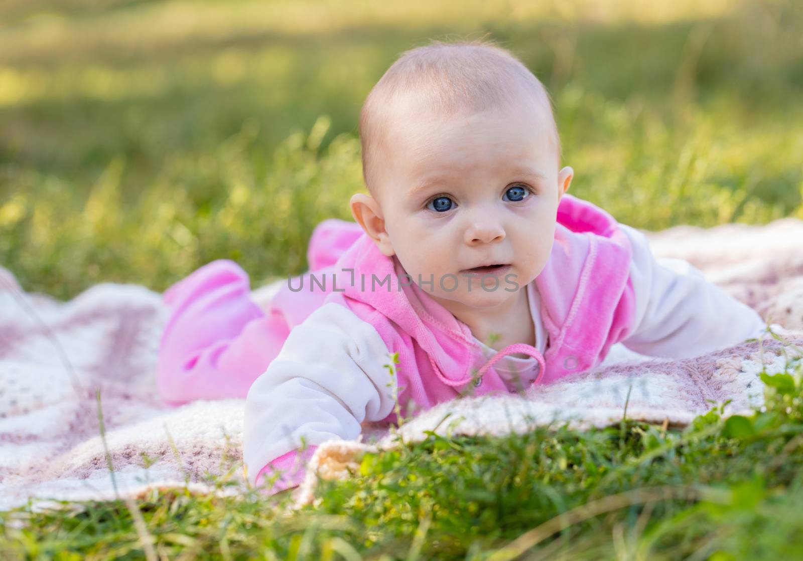 portrait of a smiling baby girl on the grass