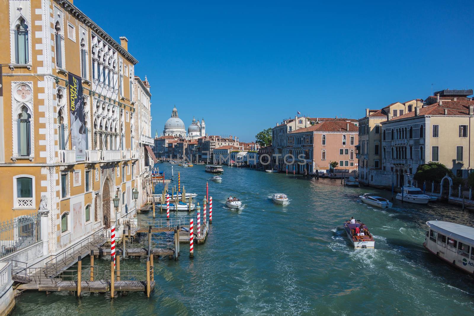 VENICE, ITALY - AUGUST 7 2016: Tourists floating on a boat, Venice, Italy