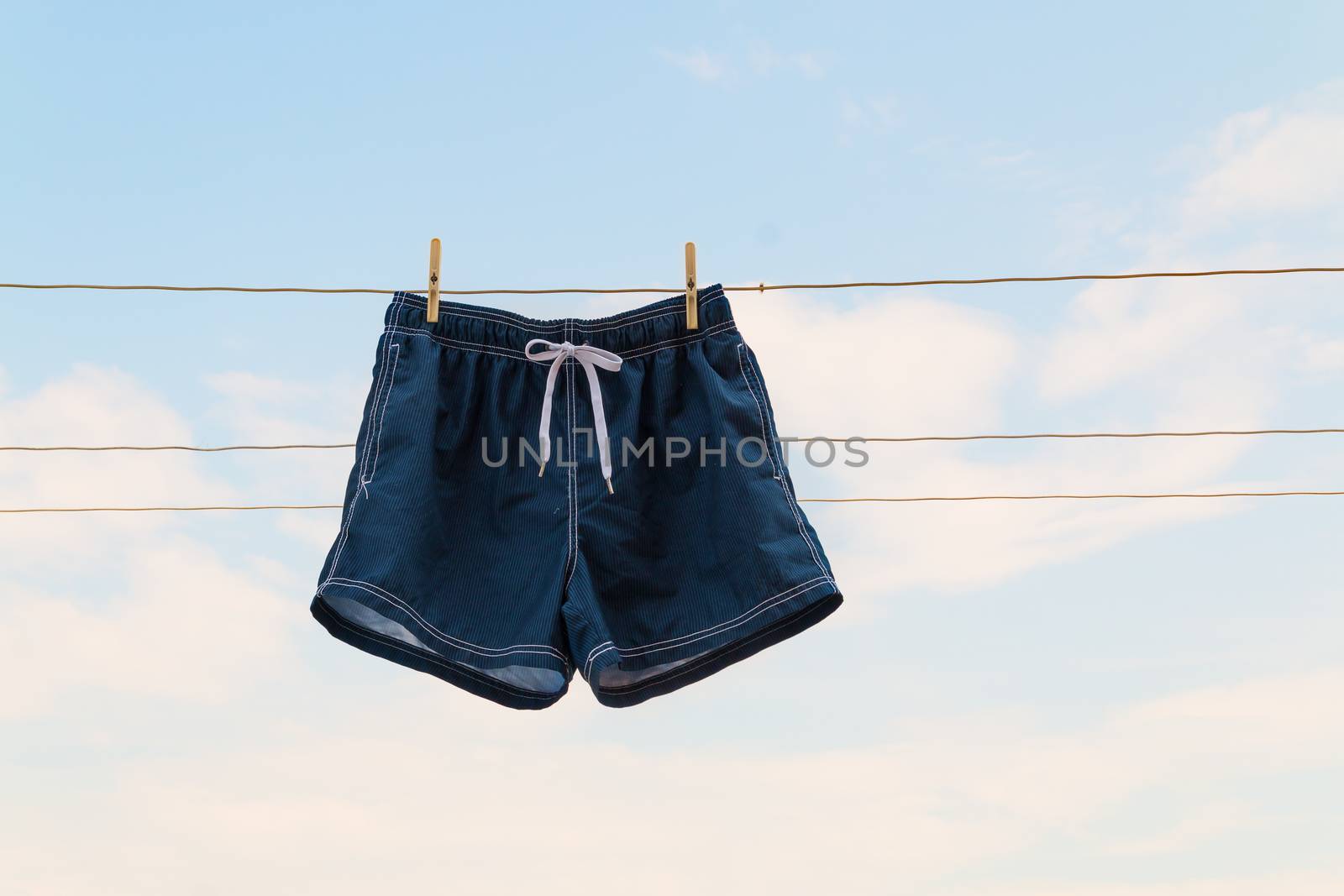 shorts hanging on the clothesline on sky background