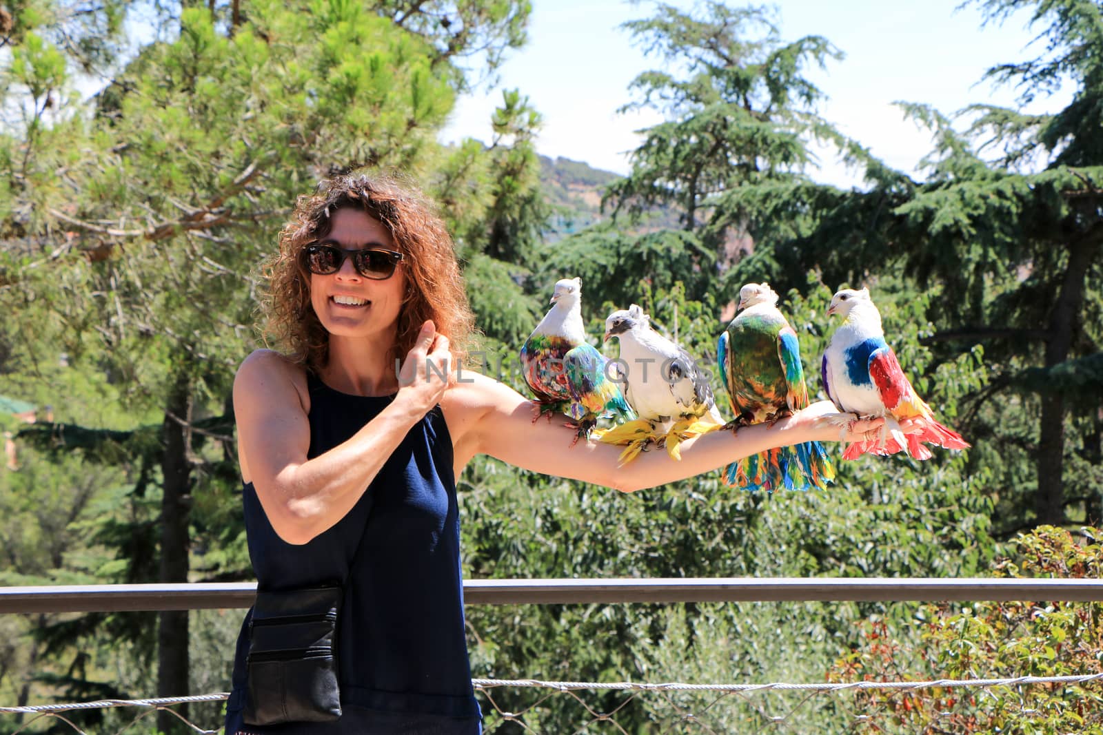 Amazingly beautiful birds in the Park Guell on the beautiful young girl.