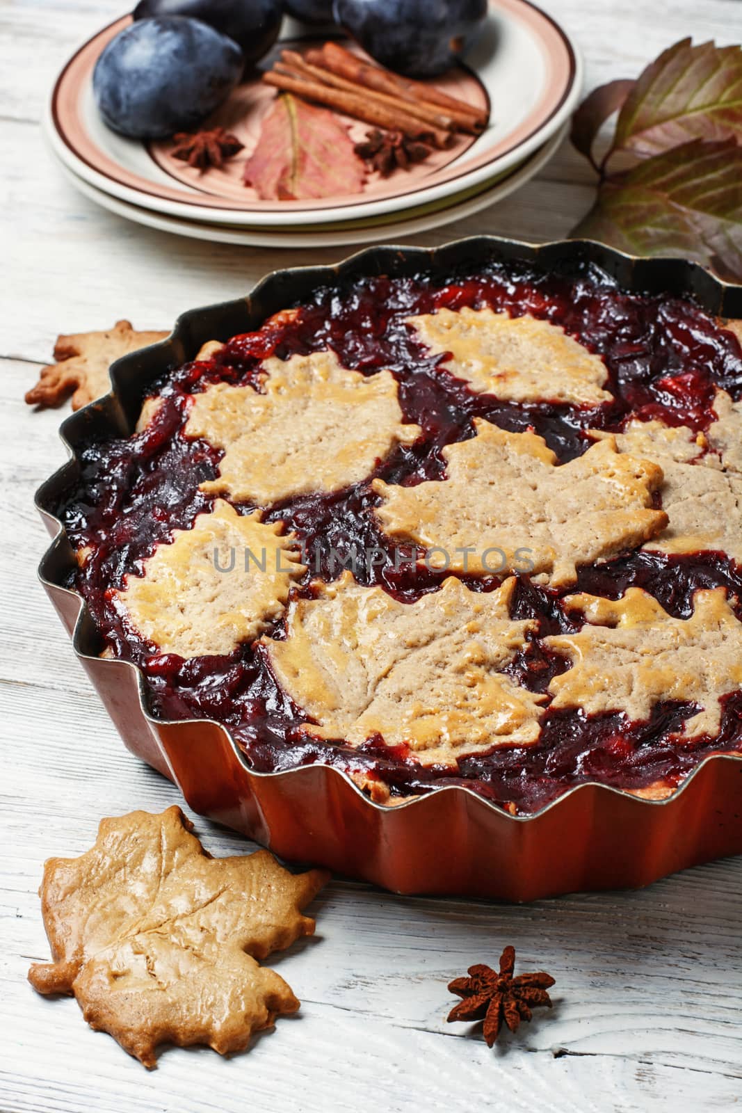 Autumn pie with plum decorated cakes in the form of leaflets